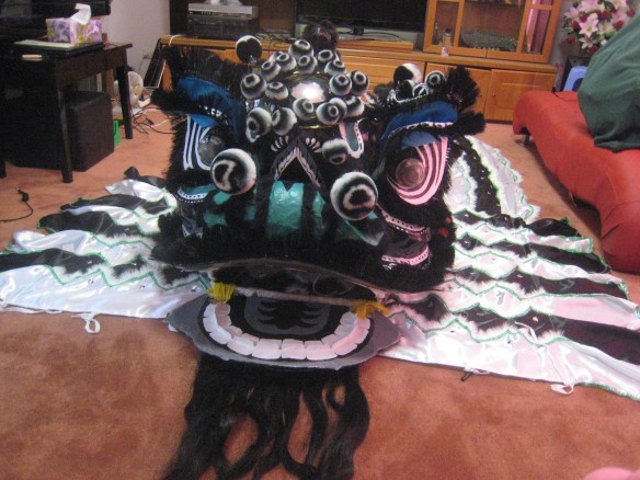 Front on view of lion. sitting on its new tail